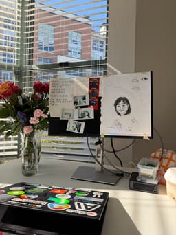 Desk with flowers, drawings, and photos